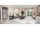 Stylish living room with sleek furniture, neutral decor, and sliding glass doors leading to a patio at 3824 Bluethread Way, Poinciana, FL 34759