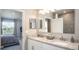 Bright main bathroom with double vanity, granite countertops, and a view of the main bedroom at 3824 Bluethread Way, Poinciana, FL 34759