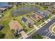 An aerial view of houses with solar panels located close to a lake and surrounded by well-manicured lawns at 4469 Biscayne Breeze Way, Kissimmee, FL 34744