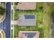 Aerial view of a house roof with solar panels, green lawn, and adjacent neighborhood street at 4469 Biscayne Breeze Way, Kissimmee, FL 34744