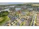 Picturesque aerial view of a residential area with a lake and well-maintained homes, some featuring solar panels at 4469 Biscayne Breeze Way, Kissimmee, FL 34744