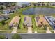 Aerial view showcasing homes with solar panels, driveways, and manicured front yards at 4469 Biscayne Breeze Way, Kissimmee, FL 34744