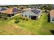 Backyard with a covered patio, green grass, and solar panels on roof of home at 4469 Biscayne Breeze Way, Kissimmee, FL 34744