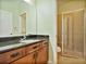 Bathroom featuring granite counters, single sink and a walk-in shower at 4469 Biscayne Breeze Way, Kissimmee, FL 34744