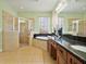 Bathroom featuring walk-in shower, soaking tub, granite counters, and double sinks at 4469 Biscayne Breeze Way, Kissimmee, FL 34744