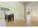 Dining room featuring neutral walls, tile floors, and an adjacent room with natural light at 4469 Biscayne Breeze Way, Kissimmee, FL 34744