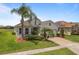 Inviting single-Gathering home showcasing well-manicured lawn and mature palm trees adding curb appeal at 4469 Biscayne Breeze Way, Kissimmee, FL 34744