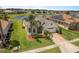 Attractive single-Gathering home with a well-manicured lawn, mature landscaping, and brick paver driveway at 4469 Biscayne Breeze Way, Kissimmee, FL 34744
