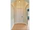 Entryway featuring archways, neutral walls, a white front door, and tile flooring at 4469 Biscayne Breeze Way, Kissimmee, FL 34744