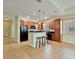 Open kitchen with wood cabinets, tile flooring, breakfast bar, and adjacent dining space at 4469 Biscayne Breeze Way, Kissimmee, FL 34744
