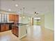 Spacious open-plan kitchen and living room with tile floors and natural light at 4469 Biscayne Breeze Way, Kissimmee, FL 34744
