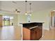 Open-concept living space featuring tile floors, a ceiling fan, and natural light at 4469 Biscayne Breeze Way, Kissimmee, FL 34744
