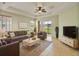 Relaxing living room with tile floors, neutral walls, a ceiling fan, and sliding glass doors at 4469 Biscayne Breeze Way, Kissimmee, FL 34744