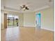 Bright living room with tray ceiling, tile flooring and sliding glass doors at 4469 Biscayne Breeze Way, Kissimmee, FL 34744