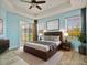 Main bedroom with natural light, ceiling fan, and sliding door to patio at 4469 Biscayne Breeze Way, Kissimmee, FL 34744