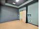 A spacious room with sleek black accents, a barn door, and neutral tile flooring at 4469 Biscayne Breeze Way, Kissimmee, FL 34744