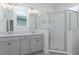 Bright bathroom featuring double vanity, glass-enclosed shower, and contemporary fixtures at 4830 Prairie Preserve Run, St Cloud, FL 34772