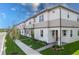 Charming townhome exterior featuring neutral tones, manicured landscaping, and a welcoming walkway to the front door at 4830 Prairie Preserve Run, St Cloud, FL 34772