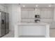 Sleek kitchen features stainless steel appliances, white cabinetry, and ample countertop space for meal preparation at 4830 Prairie Preserve Run, St Cloud, FL 34772