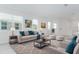 Bright living room with plush seating, modern decor, and large windows offering natural light at 4830 Prairie Preserve Run, St Cloud, FL 34772