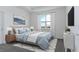 Cozy main bedroom features soft lighting, plush bedding, and a picturesque window view at 4830 Prairie Preserve Run, St Cloud, FL 34772