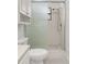 Bright bathroom featuring a glass enclosed shower with tiled walls and a toilet with overhead cabinet at 522 Boxelder Ave, Altamonte Springs, FL 32714