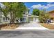 Charming two-story home with green siding, a concrete driveway, and mature trees in the front yard at 522 Boxelder Ave, Altamonte Springs, FL 32714