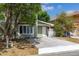 Charming two-story home with green siding, a concrete driveway, and mature trees in the front yard at 522 Boxelder Ave, Altamonte Springs, FL 32714