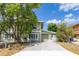 Charming two-story home with green siding, a concrete driveway, and mature trees in the front yard at 522 Boxelder Ave, Altamonte Springs, FL 32714