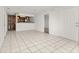 Open living area with tile flooring flowing into a kitchen with wood cabinets and stainless steel appliances at 522 Boxelder Ave, Altamonte Springs, FL 32714