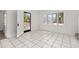 Bright living room featuring tile floors, a bay window, and a modern front door at 522 Boxelder Ave, Altamonte Springs, FL 32714