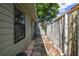 Property side yard featuring neutral toned siding, concrete pavers, and a weathered fence at 522 Boxelder Ave, Altamonte Springs, FL 32714