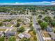 Neighborhood aerial view of residential properties with mature trees lining the streets, near a busy thoroughfare at 5811 Harcourt Ave, Orlando, FL 32839
