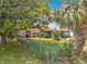Fenced backyard featuring a covered patio, mature trees, and lush landscaping offering great outdoor living at 5811 Harcourt Ave, Orlando, FL 32839