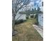 Spacious backyard with green grass, storage shed, and mature trees, offering ample outdoor space at 5811 Harcourt Ave, Orlando, FL 32839