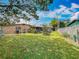 Expansive backyard featuring a covered patio and storage, perfect for outdoor living and storage at 5811 Harcourt Ave, Orlando, FL 32839