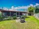Landscaped backyard featuring an outdoor grill, ideal for entertaining and enjoying the outdoors at 5811 Harcourt Ave, Orlando, FL 32839