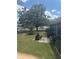 Lush backyard with mature tree, green lawn, and brick accents, creating a serene outdoor space at 5811 Harcourt Ave, Orlando, FL 32839