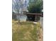 Inviting backyard with a small shed, green grass, and shady trees, creating a peaceful outdoor retreat at 5811 Harcourt Ave, Orlando, FL 32839