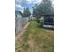 Expansive backyard featuring a well-kept lawn, wooden fence, and screened patio, perfect for outdoor enjoyment at 5811 Harcourt Ave, Orlando, FL 32839