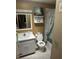 Standard bathroom featuring a vanity, toilet, and shower/tub combination with patterned curtain at 5811 Harcourt Ave, Orlando, FL 32839
