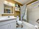 Bathroom features a white vanity, toilet, and bathtub with shower and decorative curtain at 5811 Harcourt Ave, Orlando, FL 32839