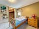 Bedroom showing twin bed, closet, tiled floors, and sunny window in this cozy room at 5811 Harcourt Ave, Orlando, FL 32839