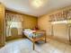 Bedroom featuring tile flooring, a cozy twin bed, and sunny windows with curtains at 5811 Harcourt Ave, Orlando, FL 32839