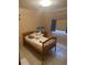 Cozy bedroom featuring a comfortable bed, tiled floor, and natural light, perfect for relaxation at 5811 Harcourt Ave, Orlando, FL 32839