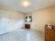 Bedroom with neutral walls, tile floors, closet, and natural light through the window at 5811 Harcourt Ave, Orlando, FL 32839