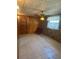 Cozy bonus room with a decorative ceiling fan, wood-paneled walls, and a brick accent wall at 5811 Harcourt Ave, Orlando, FL 32839