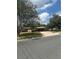 Street view of a charming home with mature trees in a quiet neighborhood, enhancing its curb appeal at 5811 Harcourt Ave, Orlando, FL 32839