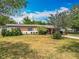 Charming single-story home with a well-maintained lawn and mature landscaping at 5811 Harcourt Ave, Orlando, FL 32839