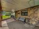 Cozy front porch with brick accents and a comfortable bench at 5811 Harcourt Ave, Orlando, FL 32839